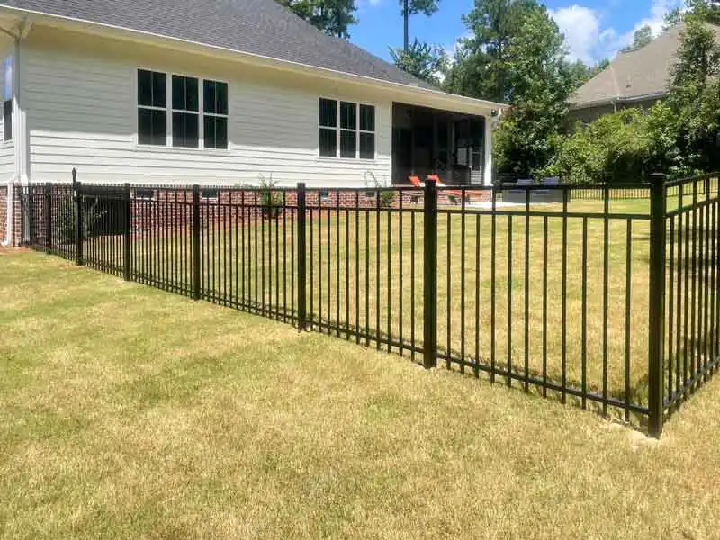 Black 3-rail aluminum fence installed with i Drive Power System steel posts